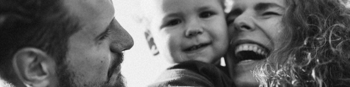 A happy family enjoying a heartfelt moment together in a black-and-white setting.
